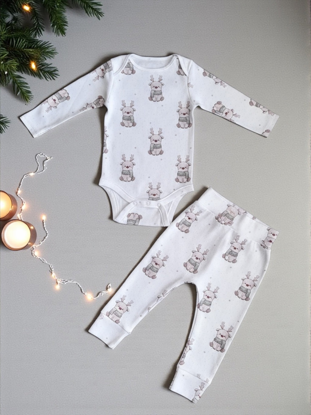 Baby onesie and leggings set with bunny pattern on a gray background